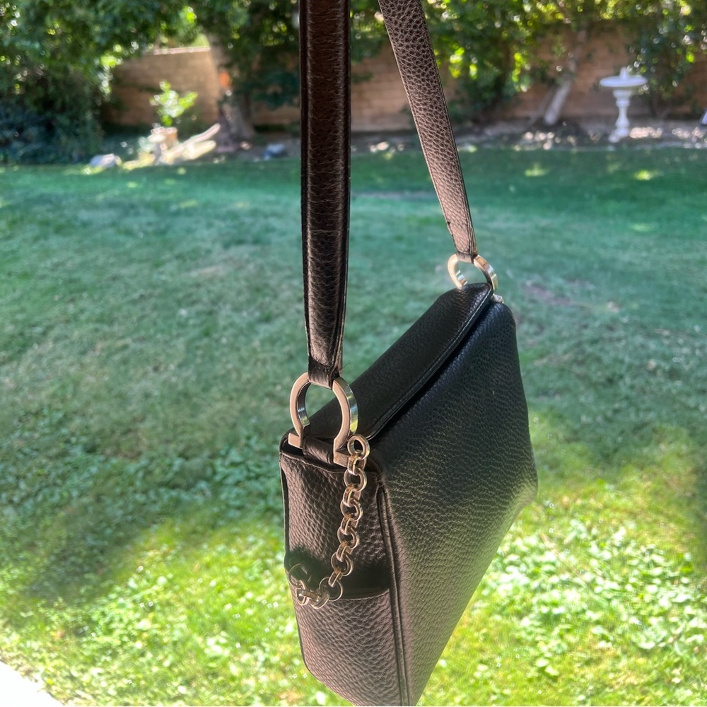 SALVATORE FERRAGAMO black pebbled leather shoulder bag with silver hardware.
